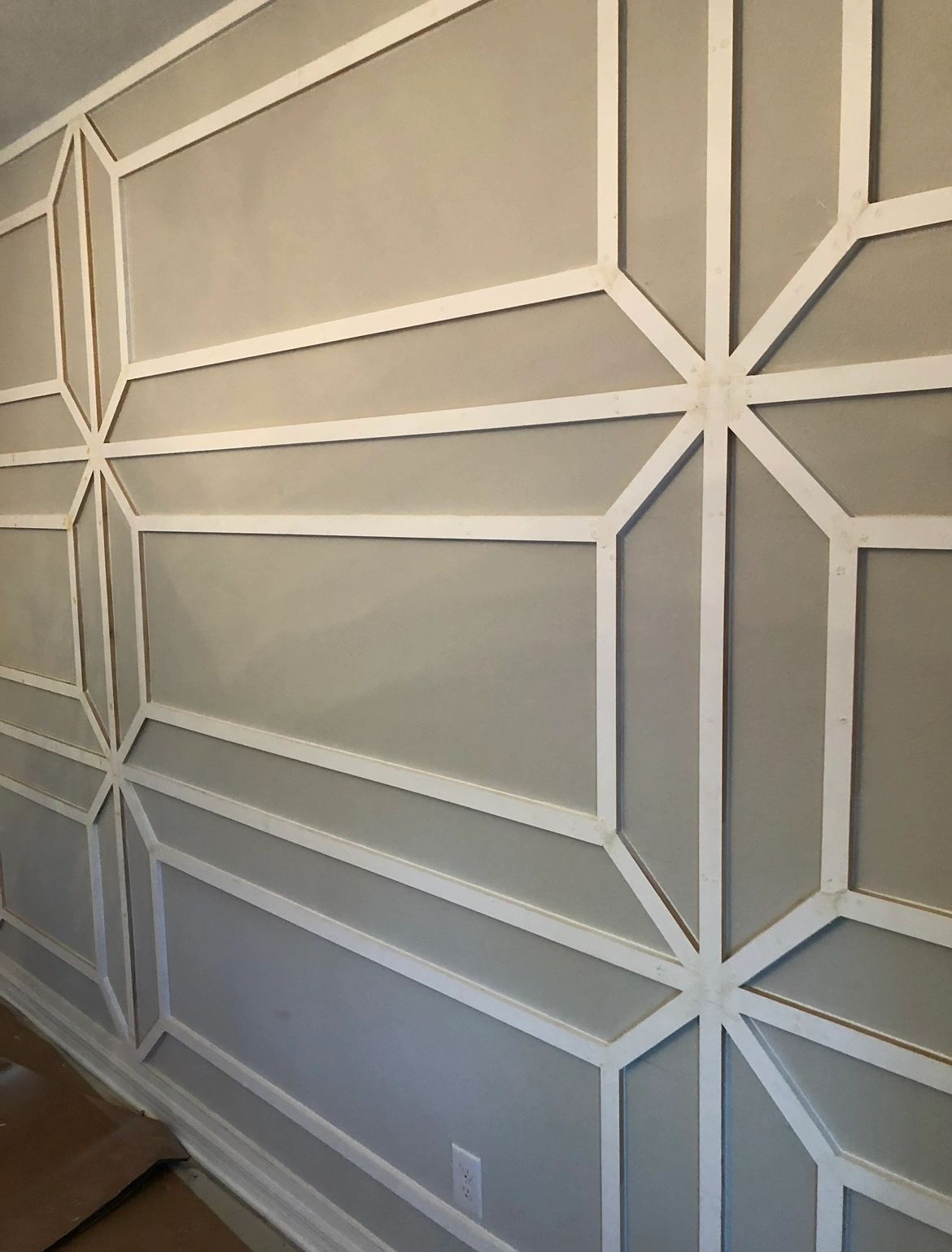 Geometric trim wall. Star-pattern trim work in one color.