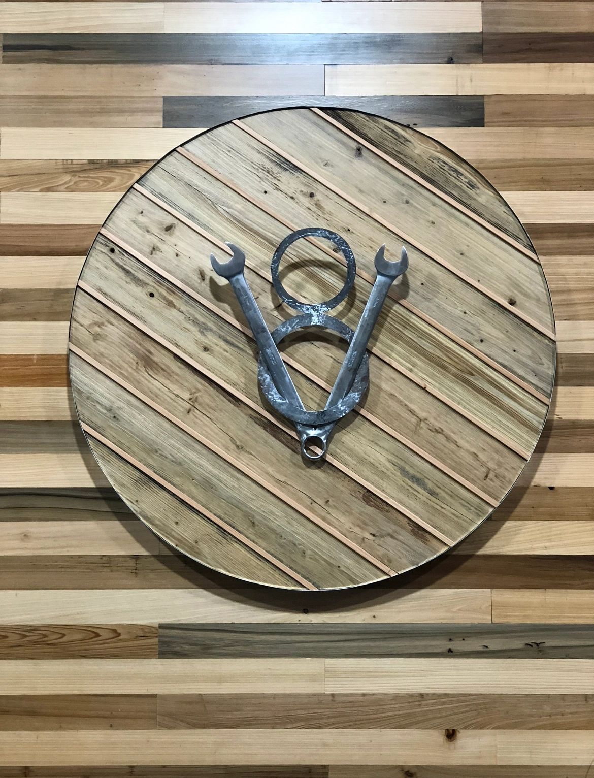 Wrench emblem round. Reclaimed boards and real wrenches.