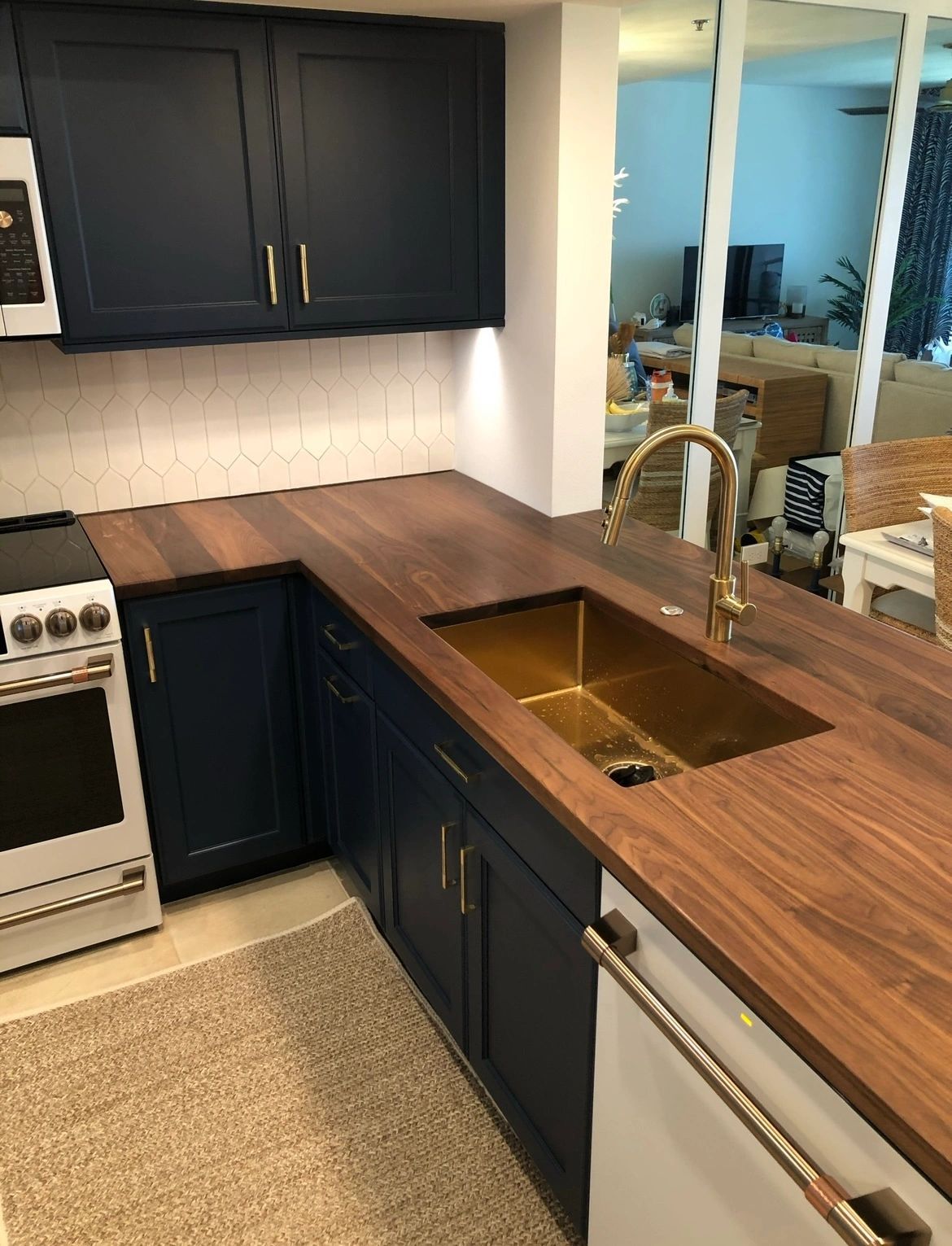 Walnut L-run. A full walnut kitchen run with an undermount brass sink.