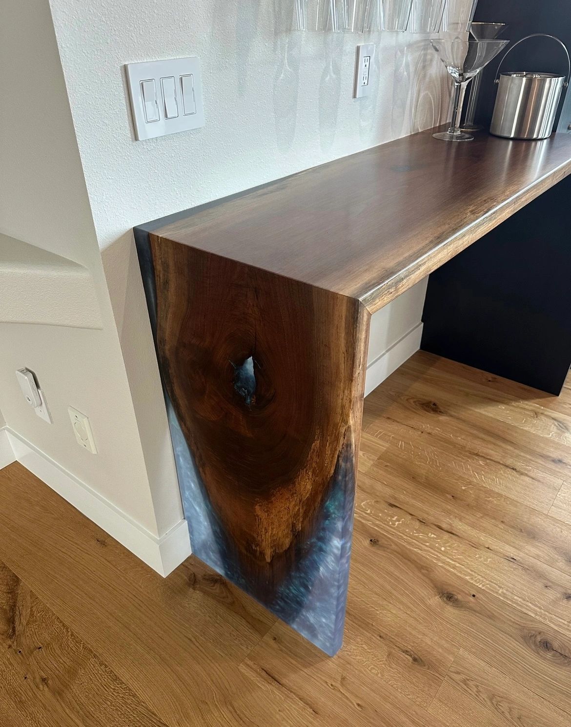 Installed black walnut waterfall bar with blue resin on the waterfall drop