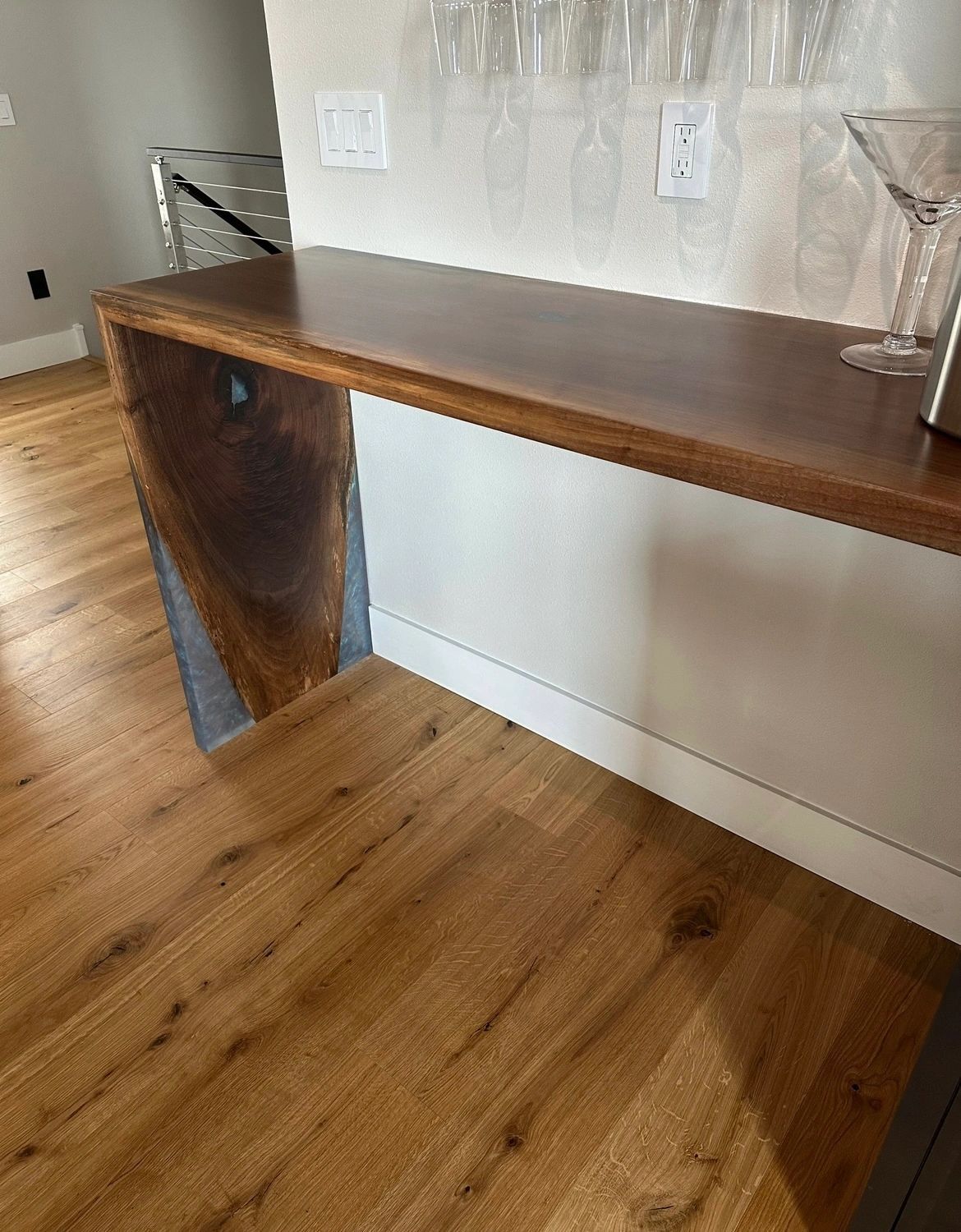 Waterfall bar, wide view. Walnut bar top dropping to a white oak floor.